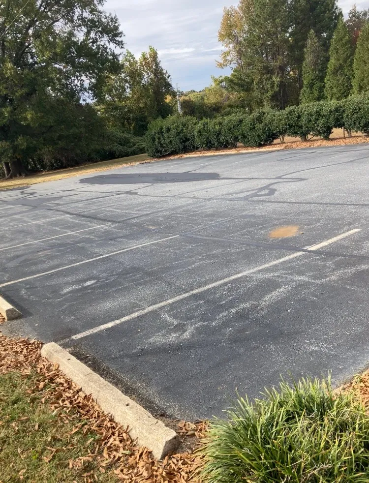 Worn parking lot lines before restriping in Greensboro NC